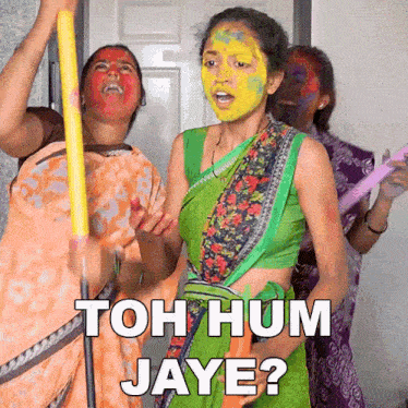 a woman with yellow paint on her face is standing next to two other women and says " toh hum jaye "
