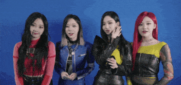 a group of four girls are standing next to each other
