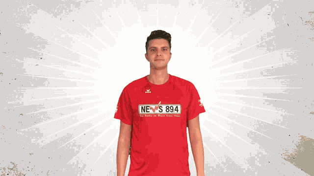 a man wears a red shirt that says news 894