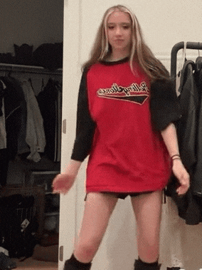 a girl is wearing a red shirt that says rolling stones on it