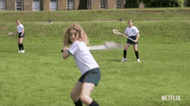 a group of girls are playing lacrosse on a field with a netflix logo in the corner .