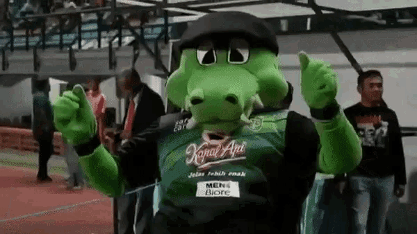 a green mascot wearing a green shirt that says kapal api
