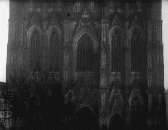 a black and white photo of a large building with lots of windows .