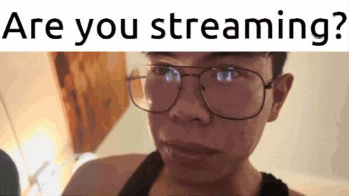 a man wearing glasses with the words " are you streaming " below him