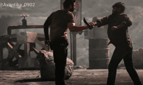 a man is holding a knife and another man is holding a gun in a photo taken by avantika_0902