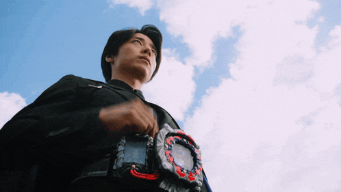 a man in a suit is holding a belt with a clock on it and looking up at the sky