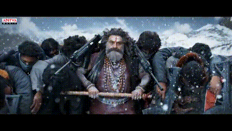 a man with a beard is holding a stick in front of a crowd .