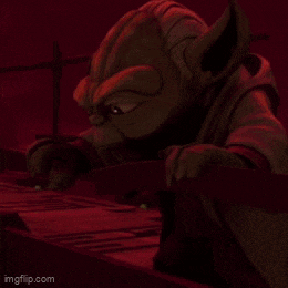 a close up of a person holding a red light saber .