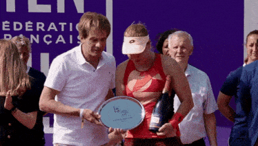 a woman holding a trophy that says " is " on it