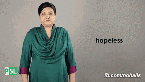 a woman in a green dress is signing the word hopeless in sign language