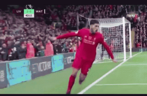 a soccer player in a red jersey is jumping in the air on a soccer field .