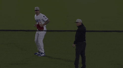a baseball player wearing a white jersey with the number 4 on it
