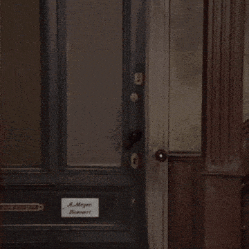 a man standing in front of a door with the word nej written on it