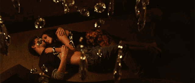 a man and a woman are laying on the floor surrounded by bubbles