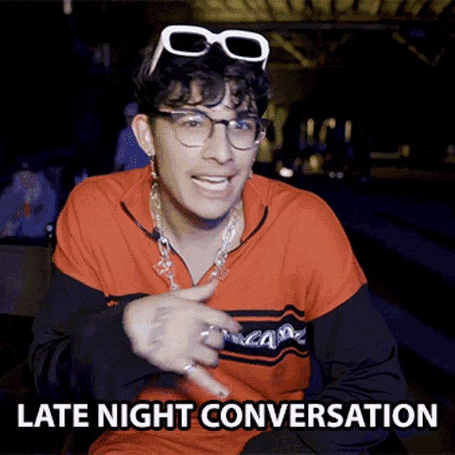 a young man wearing sunglasses and a shirt that says late night conversation on it