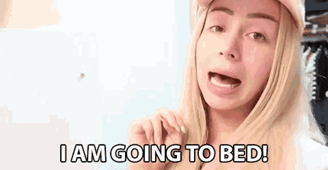 a blonde woman is wearing a pink hat and says `` i am going to bed '' .