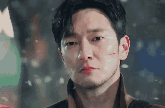 a close up of a man with a scar on his face