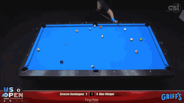 a pool table with a blue cloth and a diamond logo on it