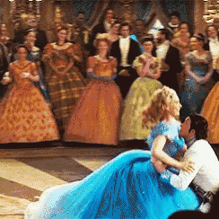 a man in a blue dress is holding a woman in a blue dress