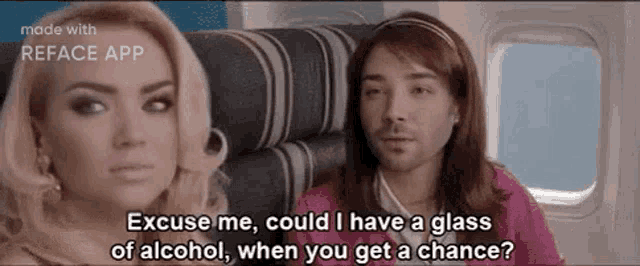 a man and a woman are sitting on a plane and the man is asking the woman if she could have a glass of alcohol .