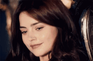 a close up of a woman 's face with a slight smile on her face .