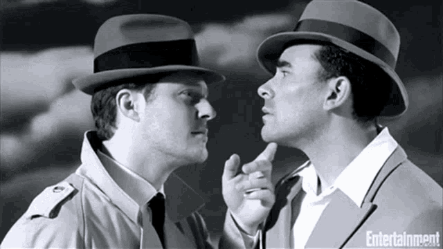 two men in hats are looking at each other with entertainment written on the bottom