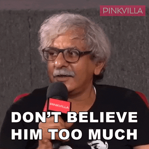 a man with glasses and a mustache holds a microphone and says " don t believe him too much "