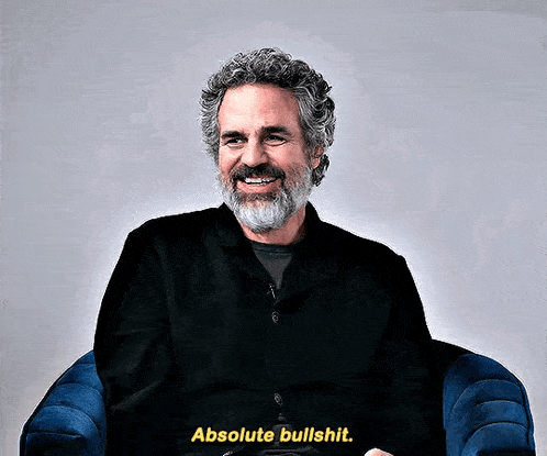 a man with a beard is sitting in a chair and says absolute bullshit .