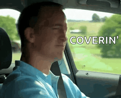 a man in a blue shirt is driving a car and says coverin ' on the screen