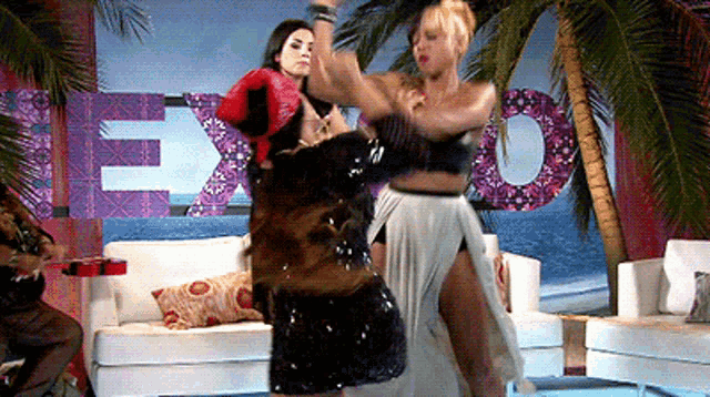 two women are boxing in front of a sign that says exo