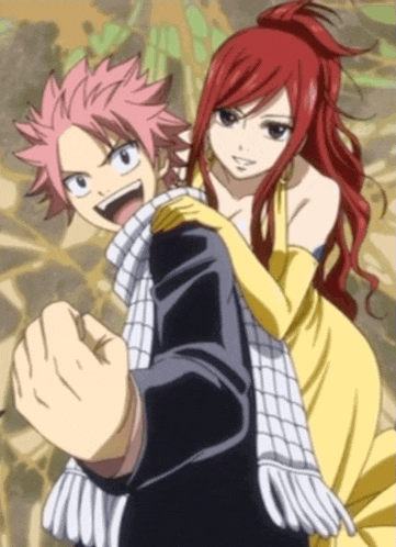 a man with red hair is carrying a woman in a yellow dress on his shoulders