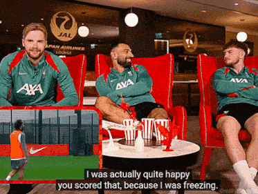a man sitting in a red chair with the word i was actually quite happy you scored that because i was freezing