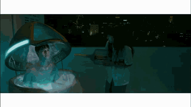 a woman in a white shirt is standing next to a man in a bathtub