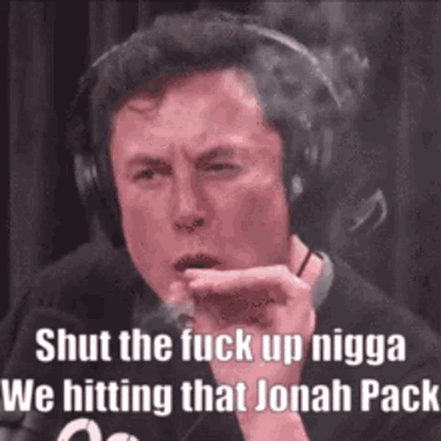 a man wearing headphones is smoking a cigarette and saying `` shut the fuck up nigga we hitting that jonah pack ''