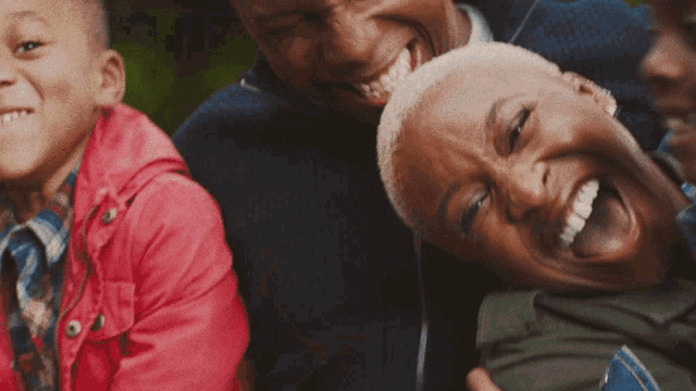 a group of people are laughing together and one of them has her tongue hanging out