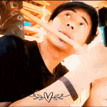 a man is holding a stick in his mouth and looking up .