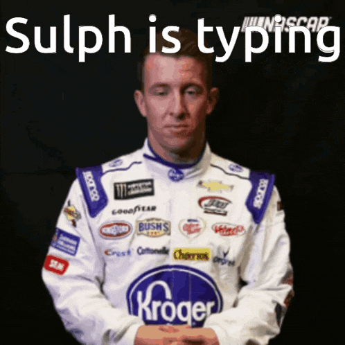 a man in a kroger racing suit is holding a card