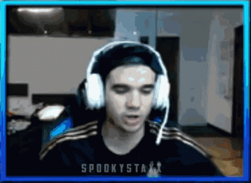 a man wearing headphones and a shirt that says spookystaxx on it