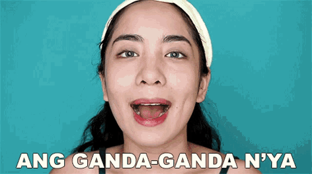 a close up of a woman 's face with the words ang ganda-ganda n'ya below her