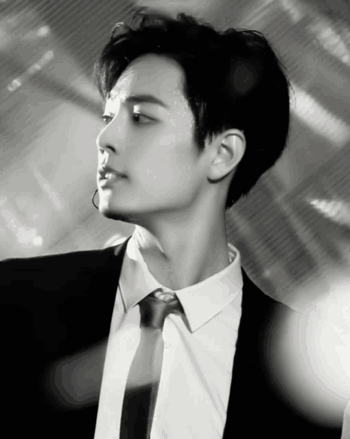 a man in a suit and tie is looking to the side