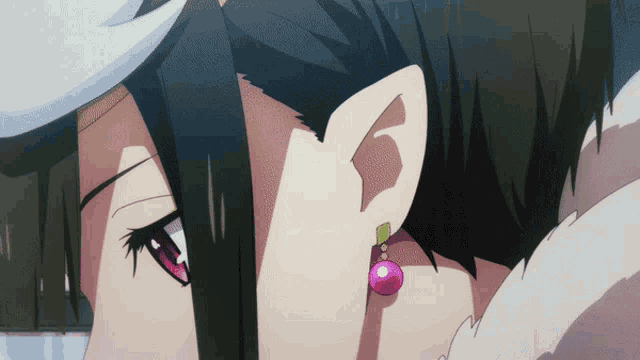 a close up of a person 's ear with a pink pearl earring