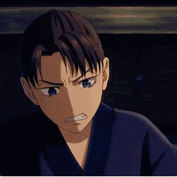 a boy in a blue kimono is making a stop gesture