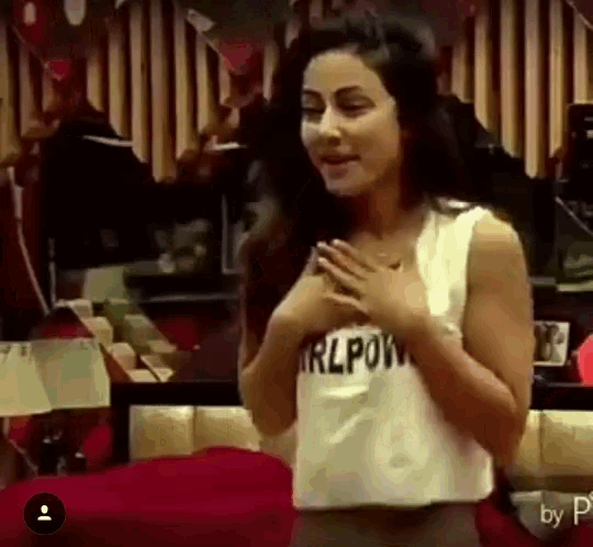 a woman wearing a white tank top that says girlpower