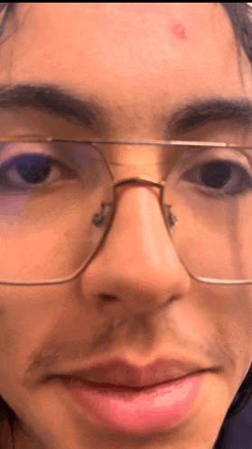 a close up of a person 's face with glasses