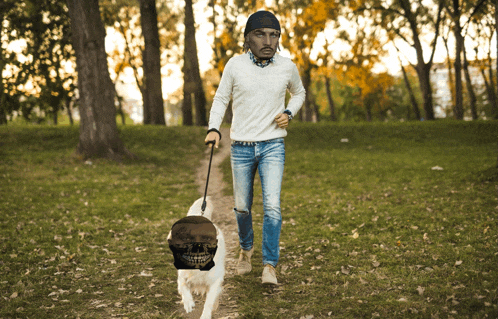 a man walking a dog in a park with a skull on the ground