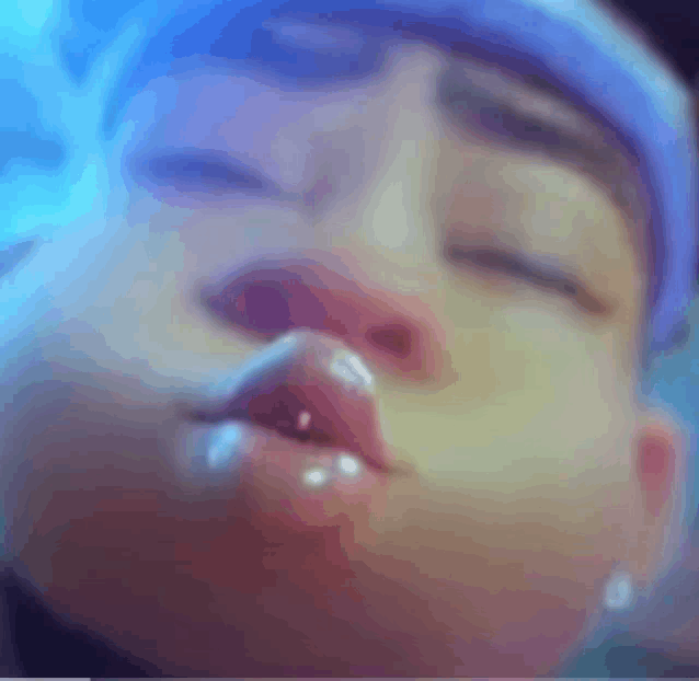 a close up of a person 's face with a blue headband on