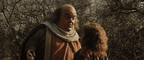 a man with a bald head is talking to another man with long hair