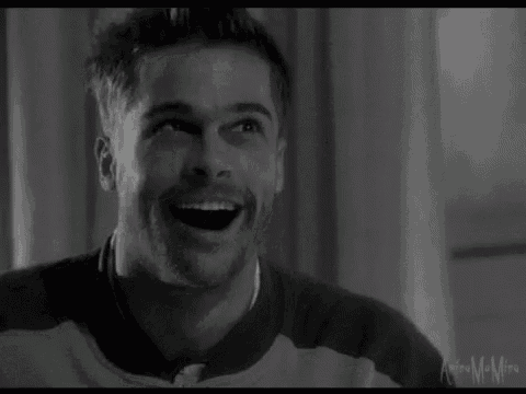 a black and white photo of a man laughing .