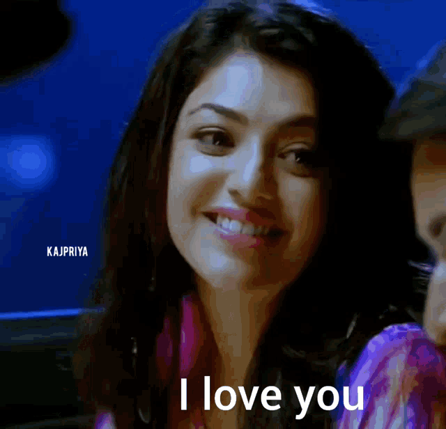 a woman is smiling and saying i love you