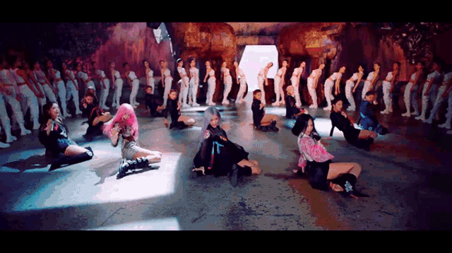 a group of people are dancing in a cave